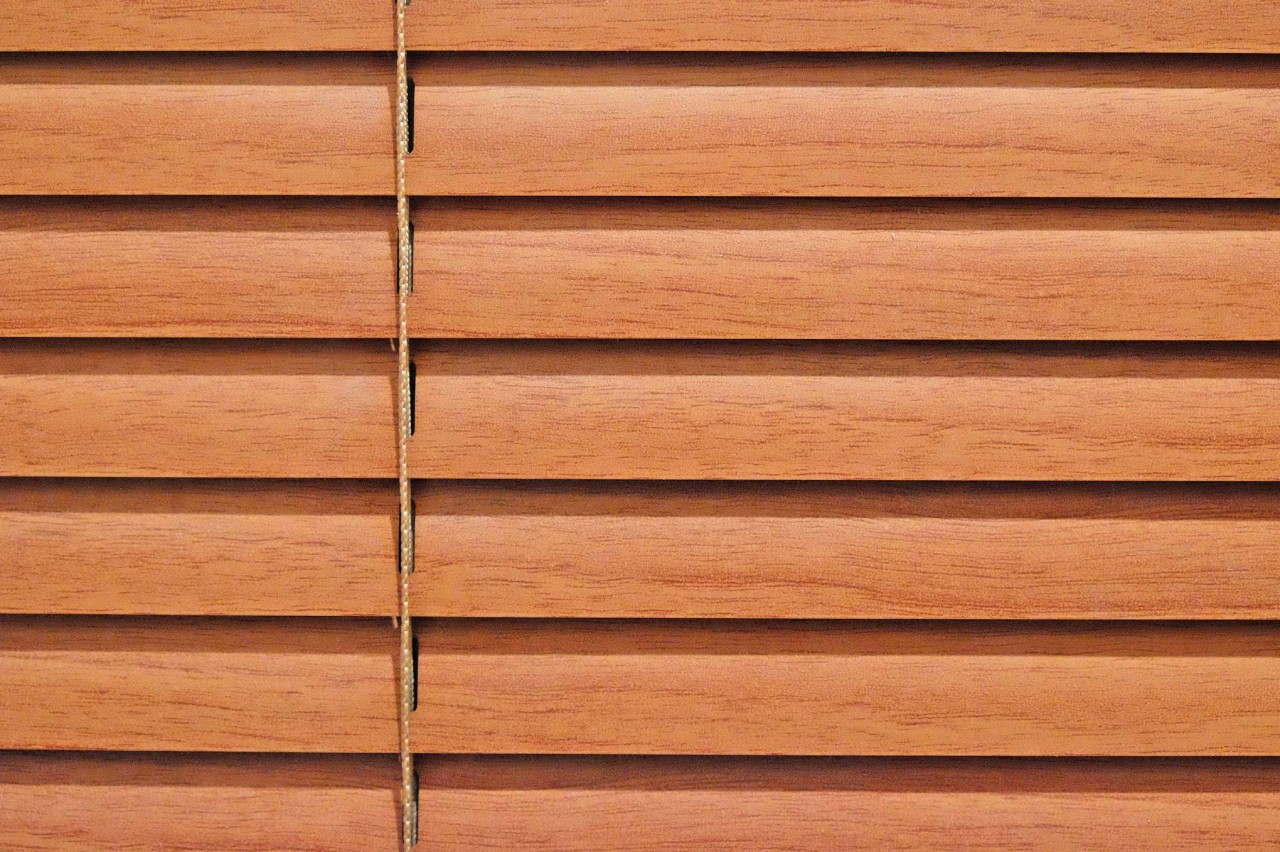 A close-up view of brown blinds on a window at Bell's Ethan Allen Design Center near Newburgh, NY