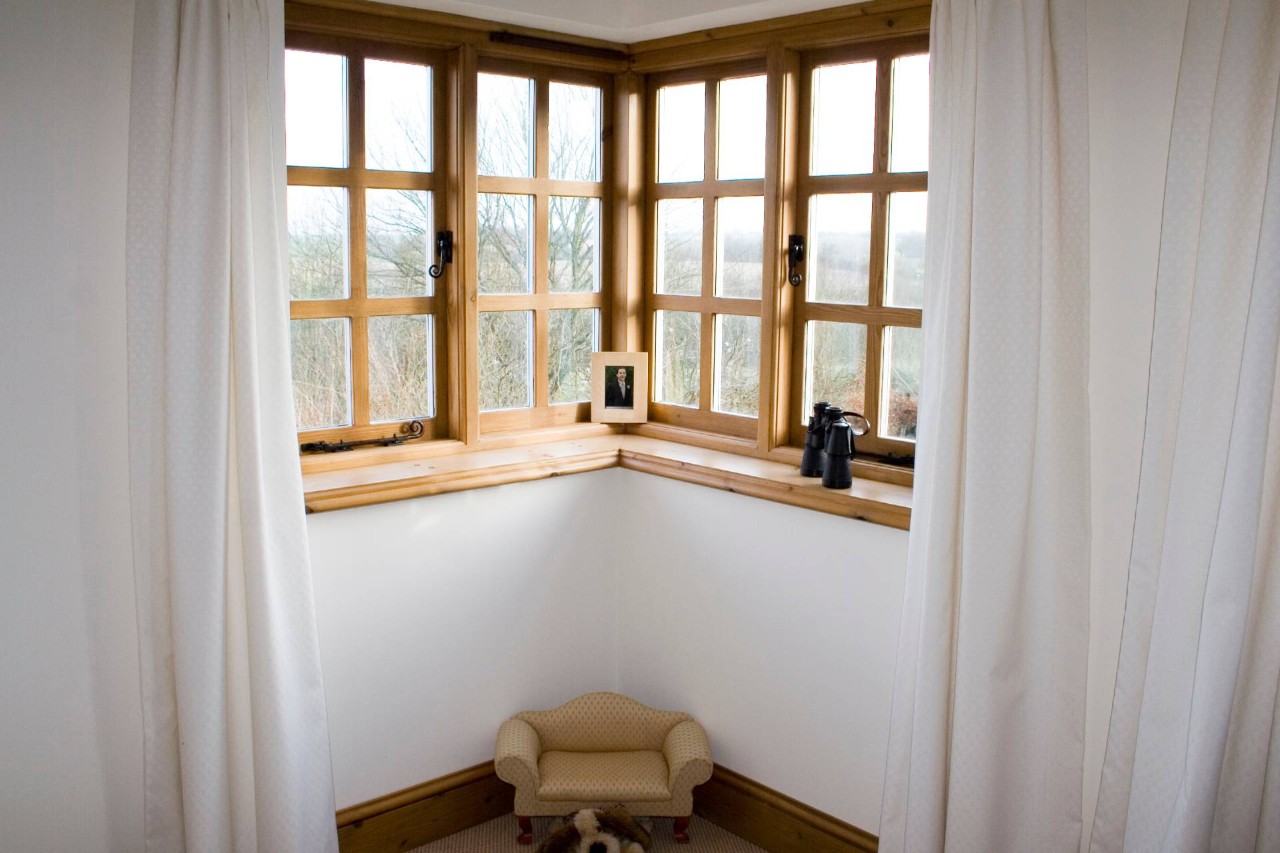 A corner window with a small seat and other decor near Newburgh, NY