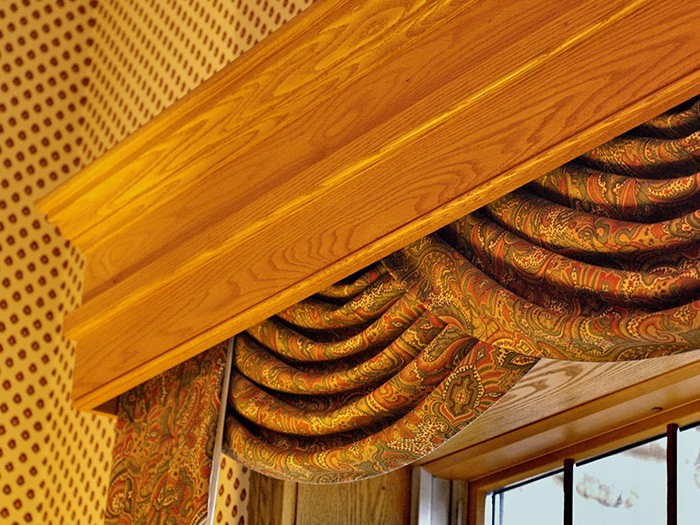 Wood cornice atop a window.